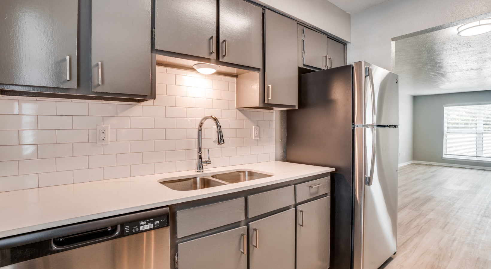 a kitchen with stainless steel appliances and a sink at The Melville