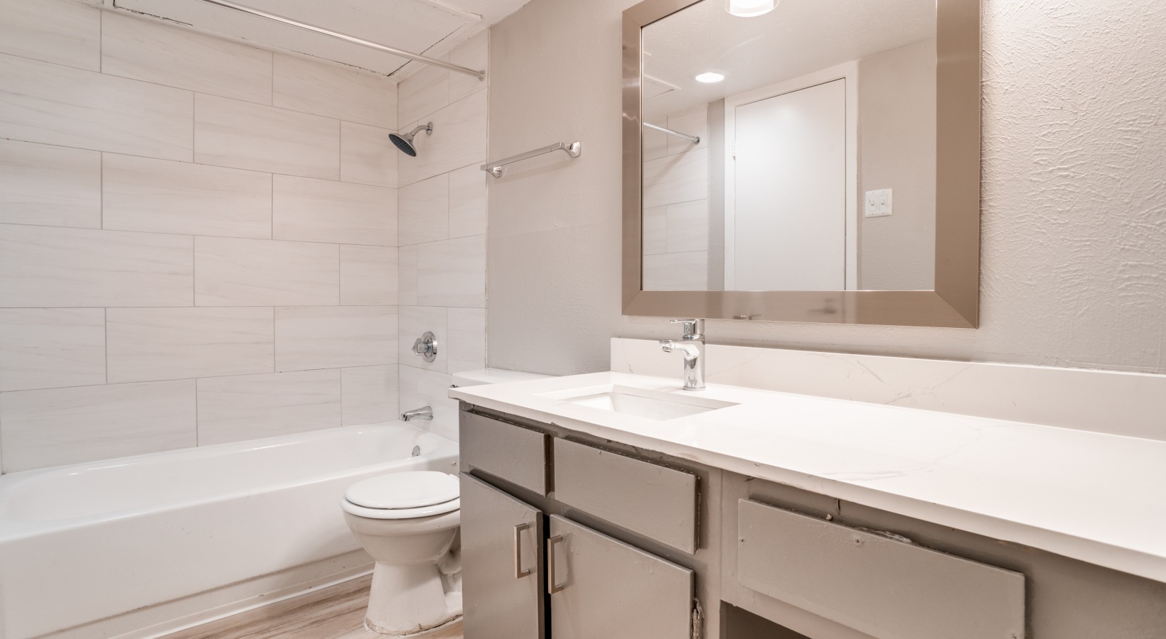 a clean bathroom with a white sink and toilet at The Melville
